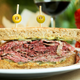 Image for article titled Anthony Bourdain Doc Under Fire For Using AI To Recreate Talking Pastrami Sandwich